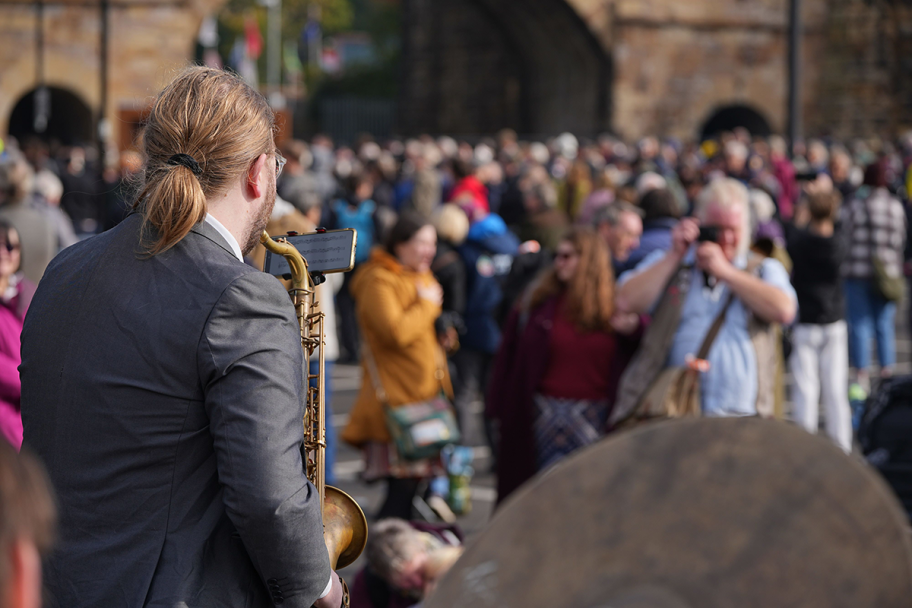 A man plays a brass instrument to a crowd at the Hopetown Anniversary Celebrations
