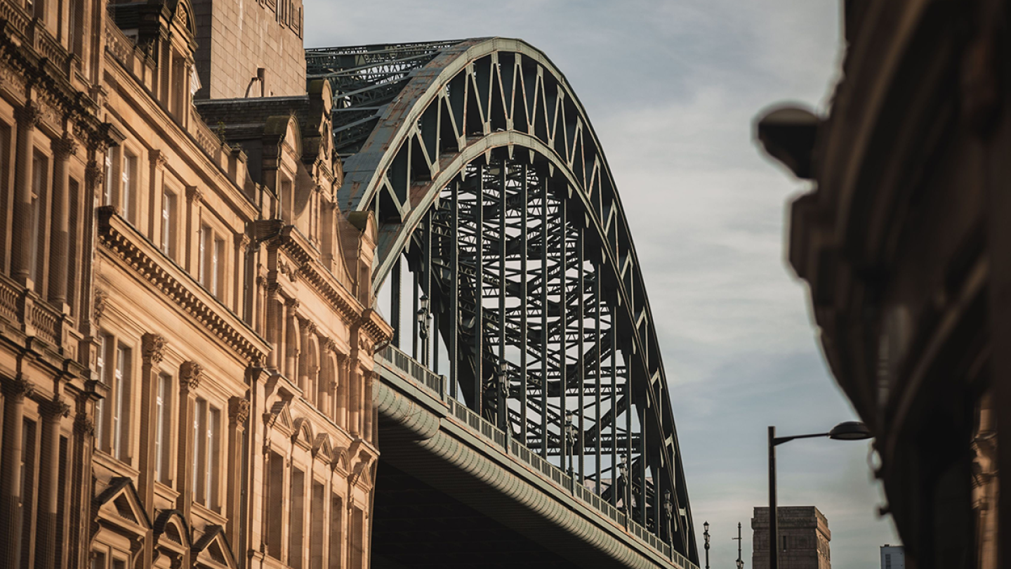 An close-up Image of the Tyne Bridge poking out between the surrounding Victorian buildings