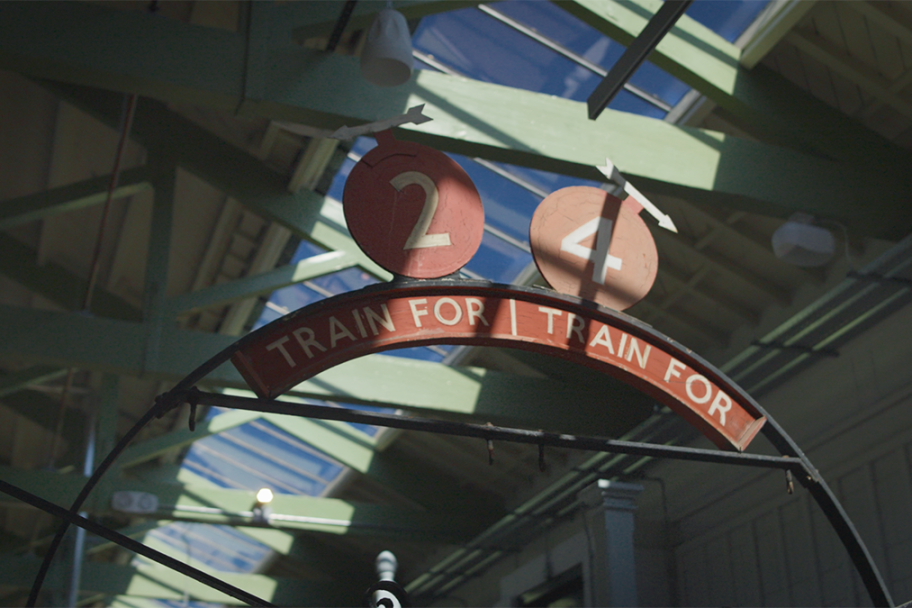 A train sign inside the replica station