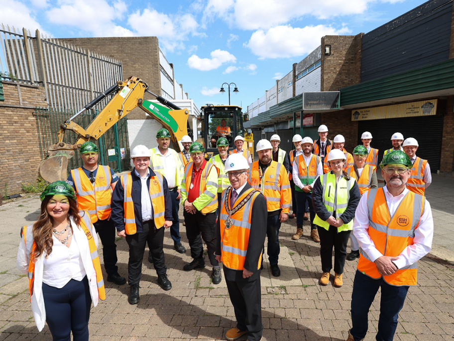 The mayor, council representatives, the RCBC project team, ESH Construction, consultants and architects, stand outside the Eston Precinct wearing high-vis jackets and hard hats