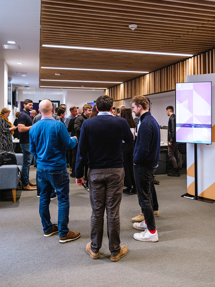 One Space 2024: People standing around chatting with cups of tea