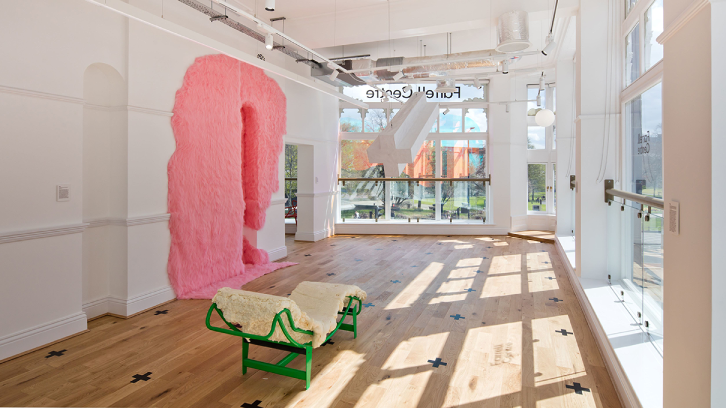 The inside of the Farrell Centre: there is a pink fluffy substance on the wall and a fluffy chair made from green metal