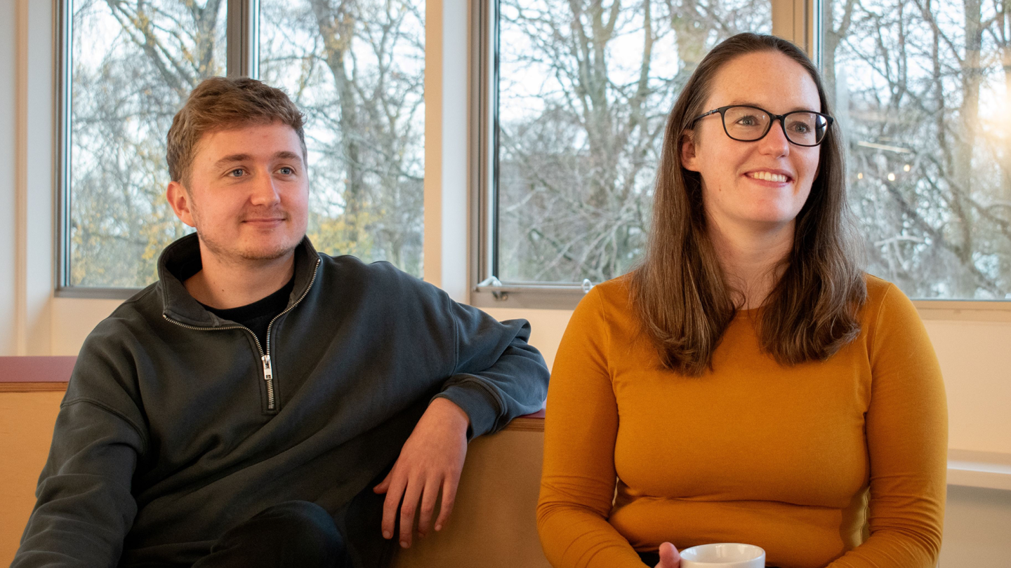Image of Charlie Kay wearing a grey jumper and Catherine Sinclair wearing a yellow, long-sleeved top