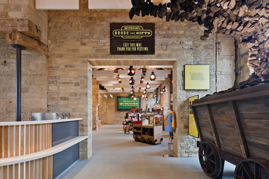 Inside of Hopetown Gift Shop, with a brown and green sign and some wooden structures