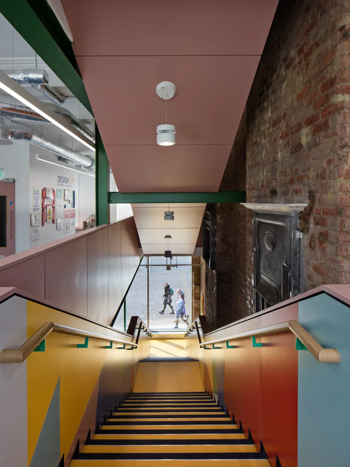A view down the main stairs in the Farrell Centre, there are people on the street below