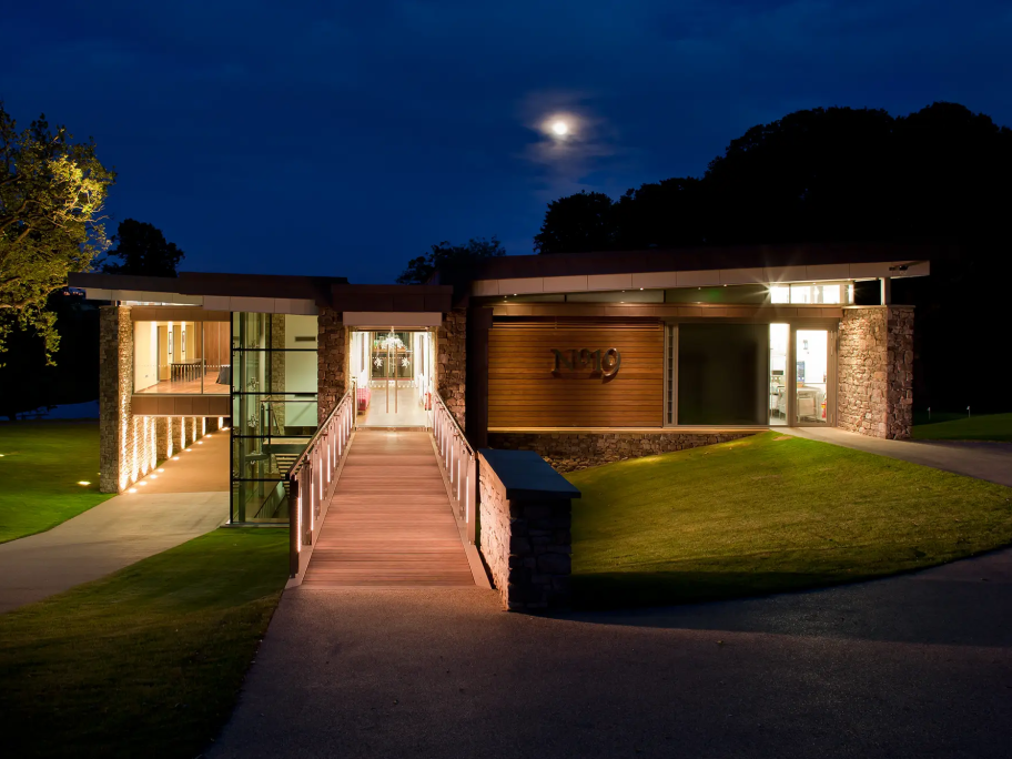 A view of the entrance of Close House clubhouse at night