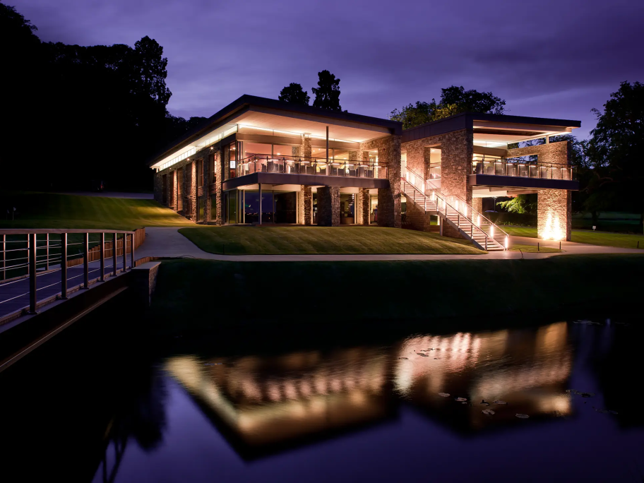 A view of Close House clubhouse across the lake in the dark