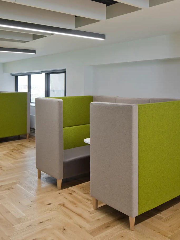 A portrait image of green and grey study pods