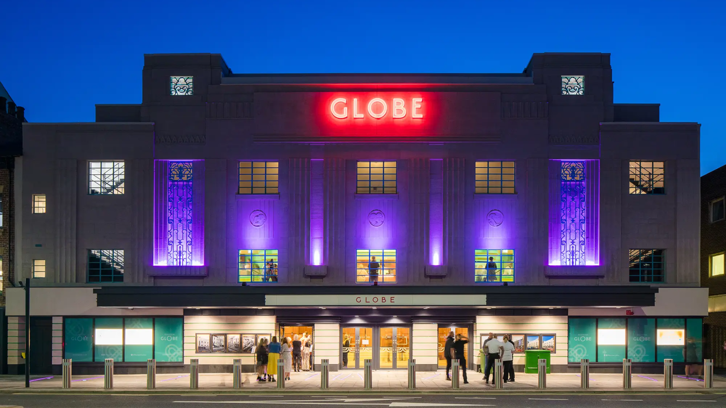 The Stockton Globe building light up at night-time