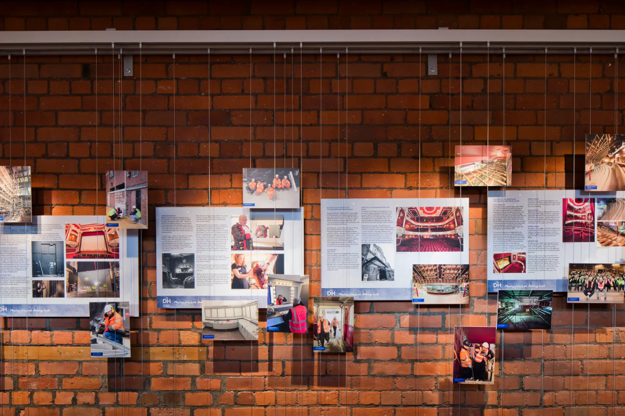 Information sheets hang against a brick wall