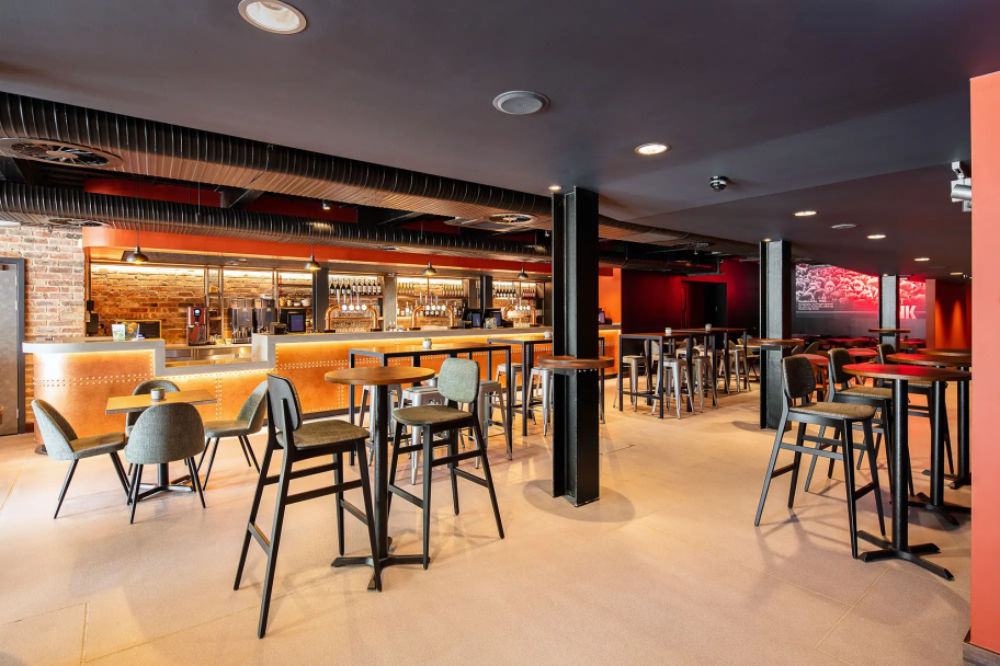 A bar with dim red lighting and black ceiling