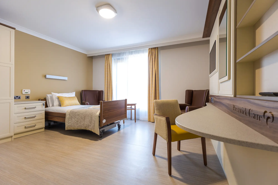 Inside a living space in Bede House, with a bed, desk space and chests of drawers
