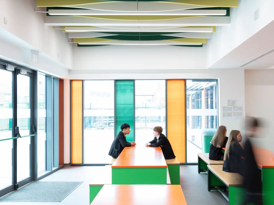 Inside the dining area, where there are orange and green seating areas