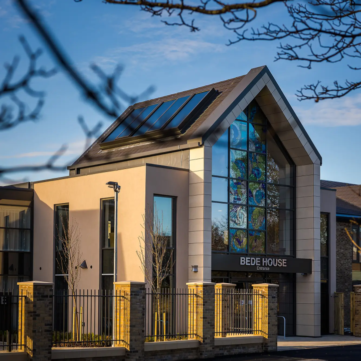 An outside across the street view of Bede House