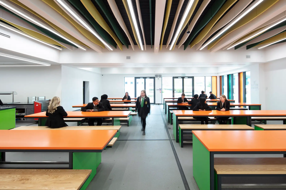 Inside St Wilfrid's R.C. College with orange dining tables