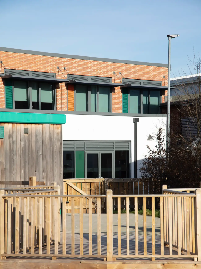 A portrait image of the orange and green accents in the central façade