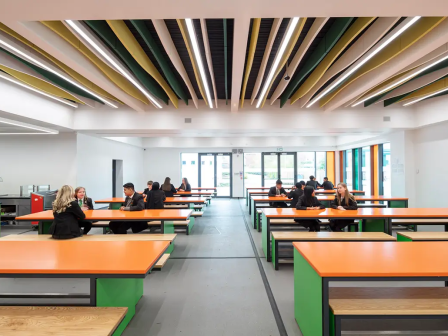 Inside St Wilfrid's R.C. College with orange dining tables