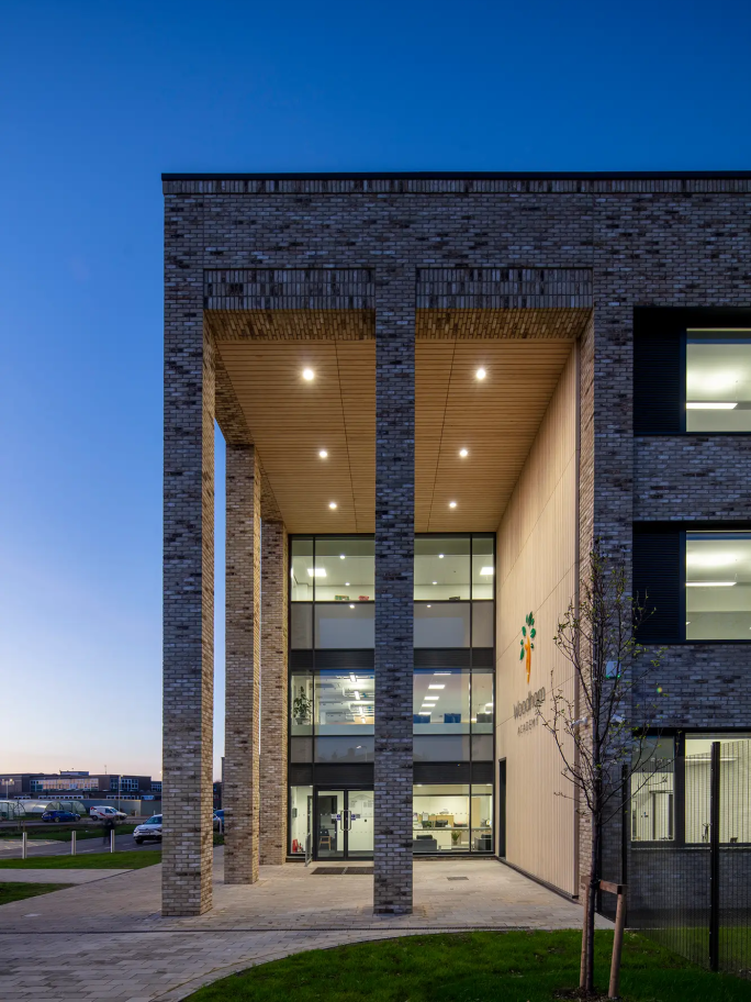 Long shot of Woodham Academy from the front at dusk