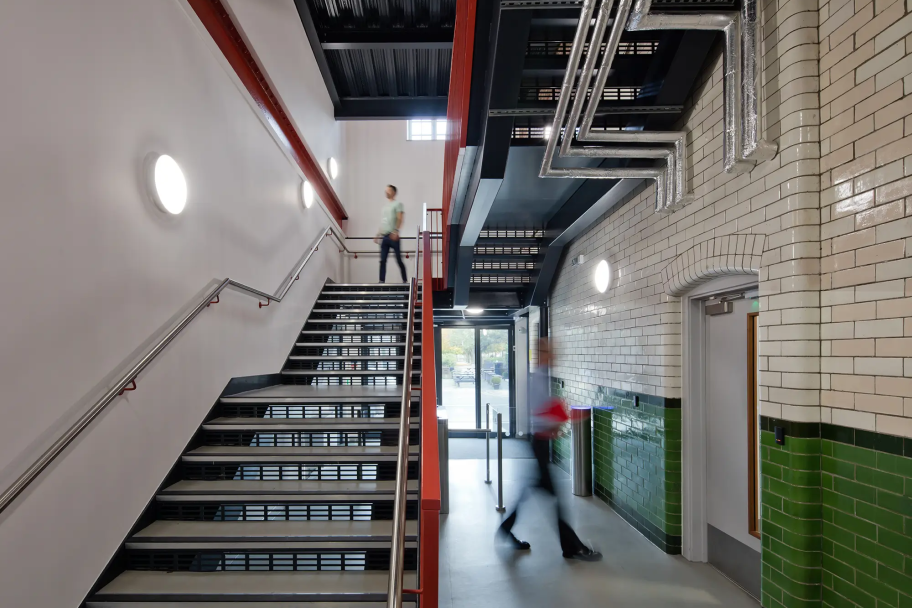 Stairwell inside STEAM studios with red metal banister