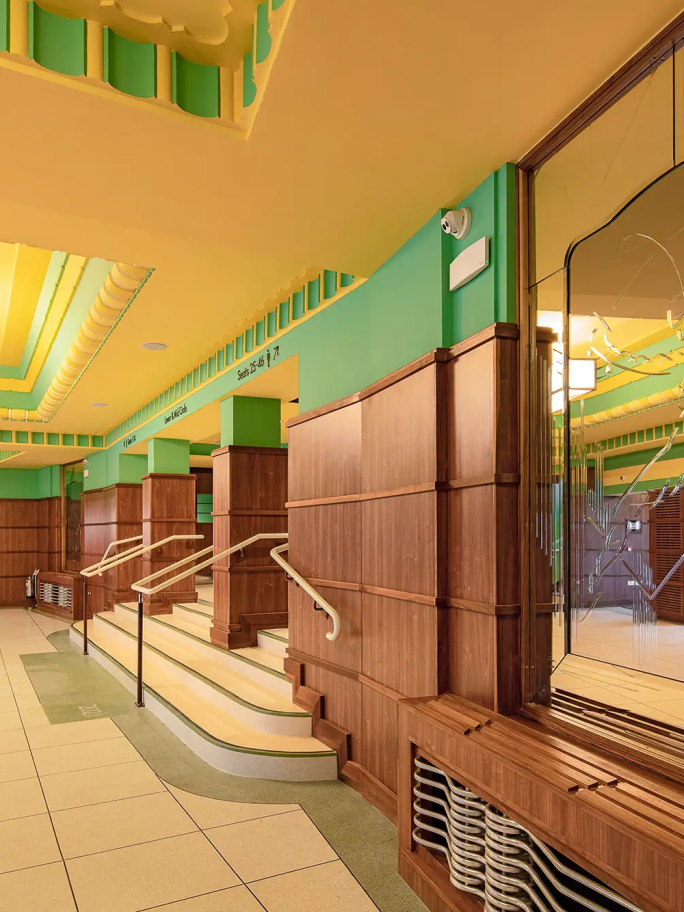 The steps leading up to the globe theatre, with wooden panelling and green and yellow paint