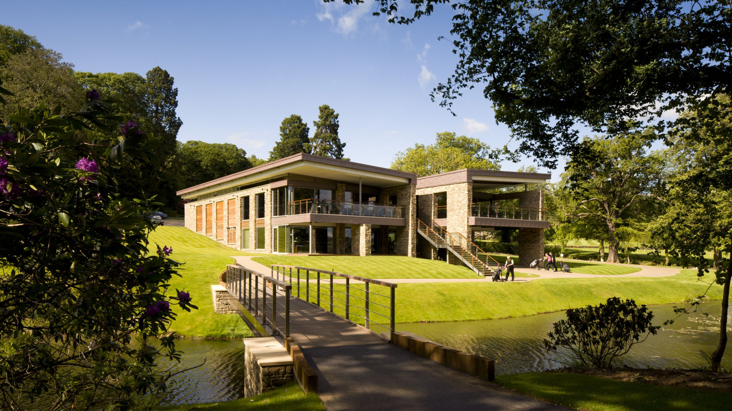 A long shot of the Close House golf clubhouse, with golfers enjoying the surrounding green area
