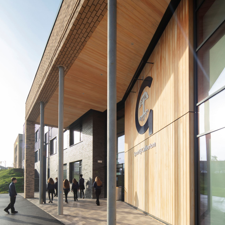 Long shot of Woodham Academy from the front at dusk