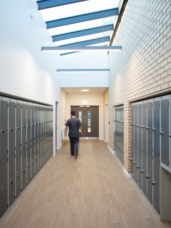 A Medic Walking Down a Brightly Lit Corridor