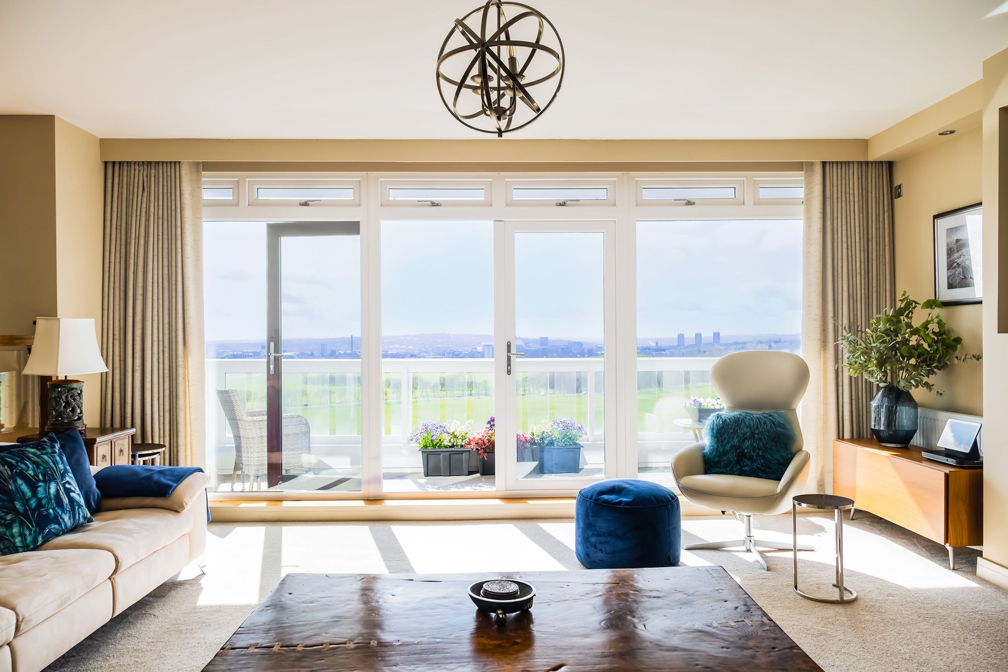 Living room of Montagu Court apartment with balcony offering views of Newcastle upon Tyne