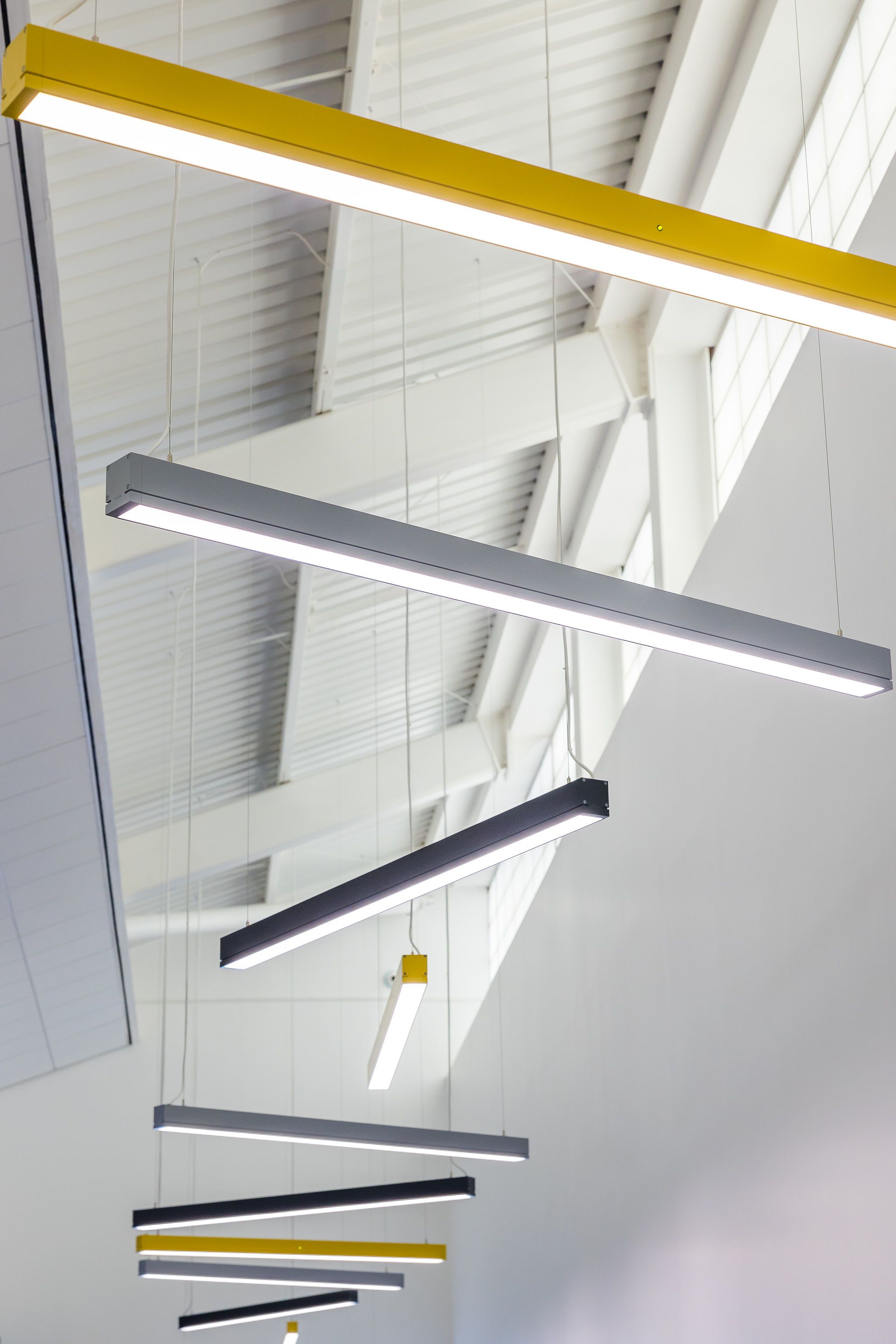 Close-up detail of lights hanging from ceiling inside Orbit Building, NETPark