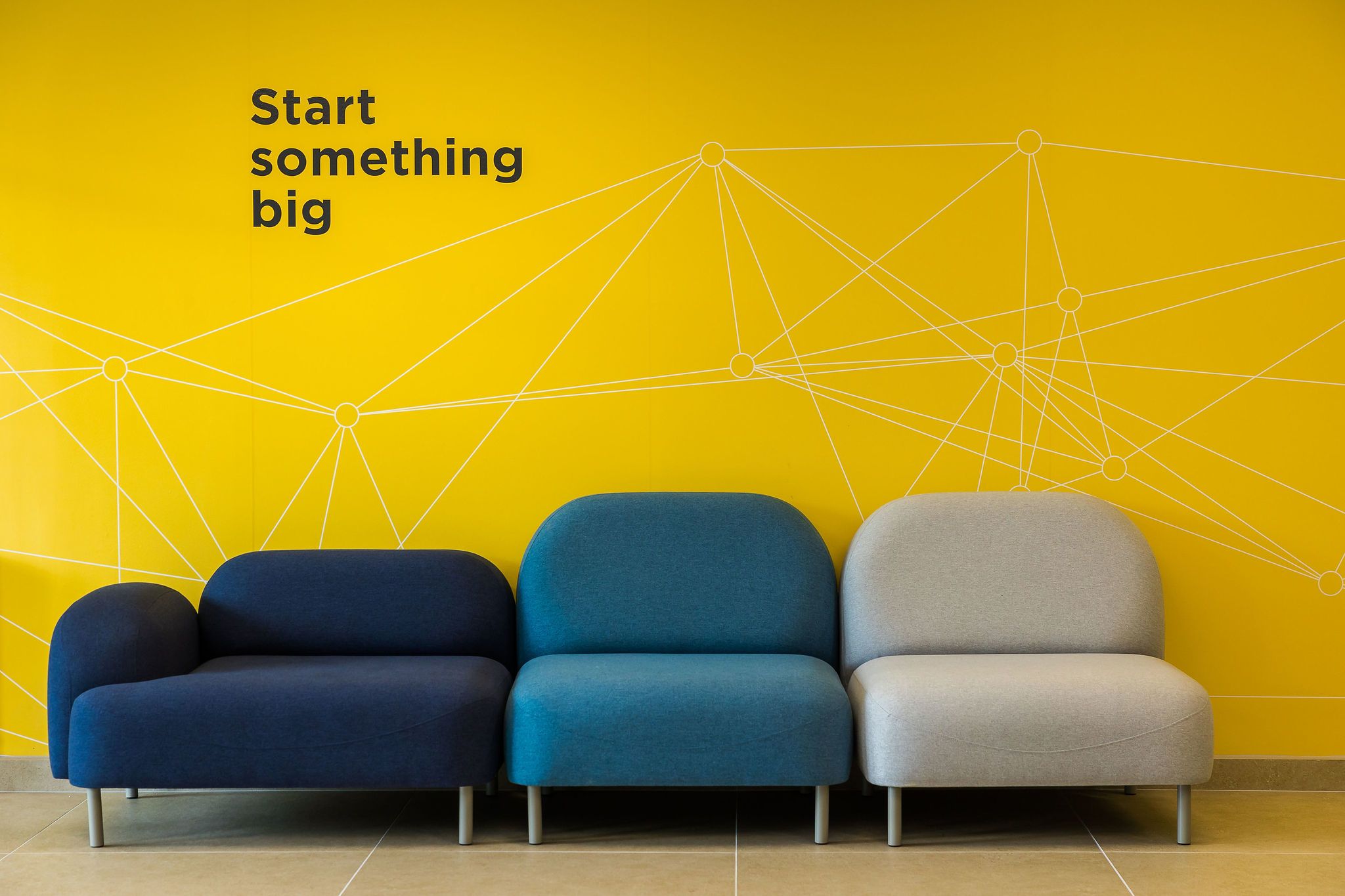 Feature wall with "Start something big" mural inside Orbit Building, NETPark