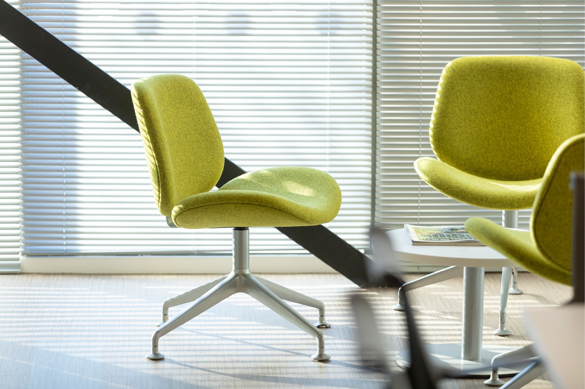 Closer detail of lime green chair in social seating area located within Northumbria University Business Incubator