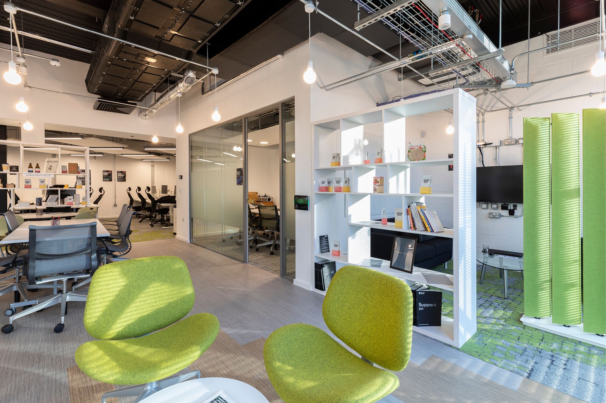 View of social seating, co-working space and meeting room located within Northumbria University Business Incubator