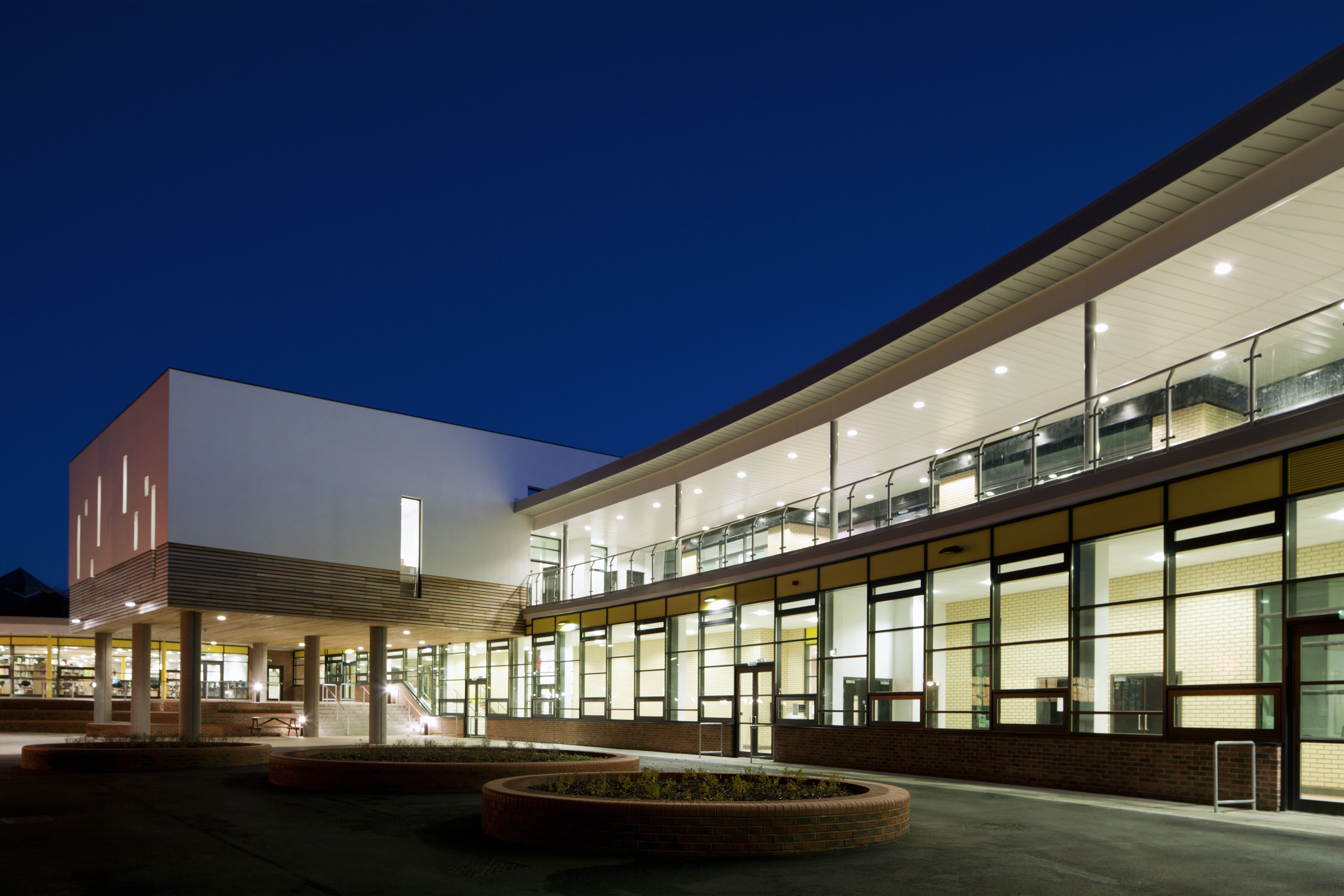 Exterior view of St Robert of Newminster School at night